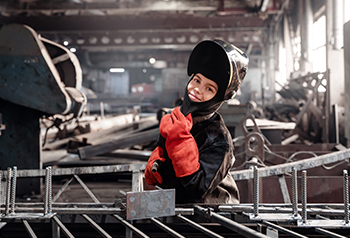 Student in welding gear in the classroom